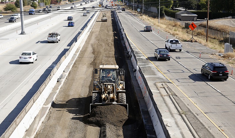 
              FILE - In this Oct. 15, 2015 file photo, vehicles pass a highway construction site on eastbound Interstate 80 in Sacramento, Calif. The House and Senate have reached agreement on a 5-year, $281 billion transportation bill that would increase spending to address the nation's aging and congested highways and transit systems _ a legislative feat that lawmakers and President Barack Obama have struggled throughout his entire administration to achieve.  (AP Photo/Rich Pedroncelli, File)
            