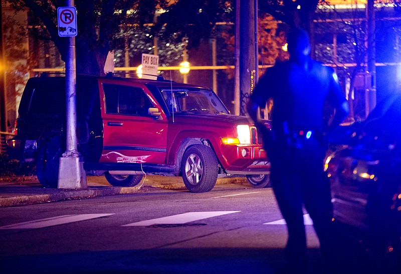 
              A police officer stands near the scene of an officer-involved shooting, Tuesday, Dec. 1, 2015, in Atlanta, that left one person dead in downtown on Monday. (AP Photo/David Goldman)
            