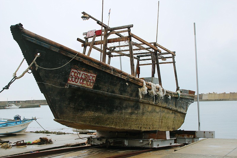 
              This Nov. 29, 2015 photo shows a ship of unknown nationality in Wajima, Ishikawa prefecture, central Japan, after it was found in mid-November off Noto peninsula and was towed to the shore.  Japanese authorities are investigating nearly a dozen wooden boats carrying decomposing bodies found drifting off the northwestern coast over the past month. Coast Guard officials said Tuesday, Dec. 1, 2015,  they have found at least 11 shoddy boats, carrying the bodies of unknown nationality since late October. They have also found fishing equipment and nets on board and signs written in Korean, suggesting they came from North Korea. (Kyodo News via AP) JAPAN OUT, CREDIT MANDATORY
            