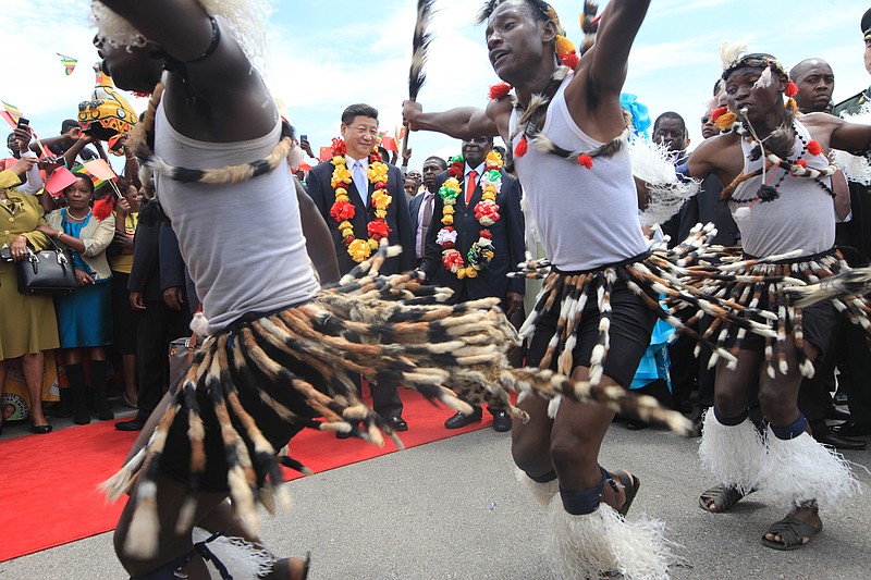 
              Chinese President Xi Jinping, centre, and Zimbabwean President Robert Mugabe, centre right,  watch a performance by Zimbabwean traditional dancers upon his arrival in Harare, Zimbabwe, Tuesday, Dec. 1. 2015. Jinping is in Zimbabwe for a two day State visit during which he is set to sign some bilateral agreements aimed at strengthening relationships between the two countries. (AP Photo/Tsvangirayi Mukwazhi)
            