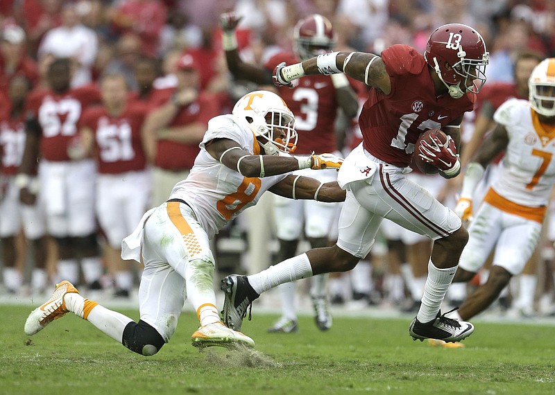 In this Oct. 24, 2015, photo, Alabama wide receiver ArDarius Stewart (13) runs after he catches a pass over Tennessee defensive back Justin Martin (8) during the second half of an NCAA college football game in Tuscaloosa, Ala. 