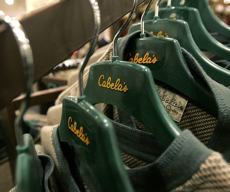 FILE - In this Nov. 16, 2007, file photo, shirts hang on hangers at the Cabela's store in Lacey, Wash. Cabelas announced Wednesday, Dec. 2, 2015, that it may sell all or part of itself as it looks to boost shareholder value. (AP Photo/Ted S. Warren, File)