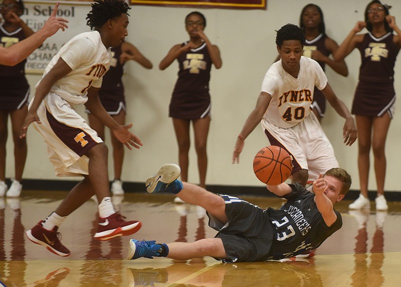 Boyd Buchanan's Andy Baumberger passes the ball as he falls in the game against Tyner Thursday, December 3, 2015 at Tyner Academy.