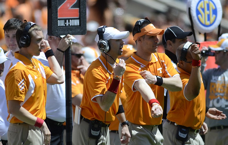 Recruiting assistant Keith Pantling, receivers coach Zach Azzanni, grad assistant Cody Kempt, and running backs coach Robert Gillespie watch the Orange and White game Saturday at Neyland Stadium.