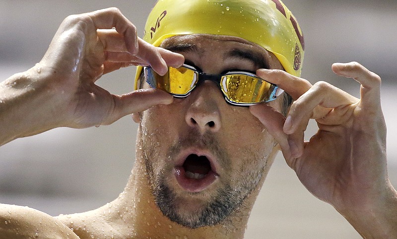 
              Michael Phelps adjusts his goggles during a practice session for the U.S. Winter Nationals swimming event Wednesday, Dec. 2, 2015, in Federal Way, Wash. Phelps will put a cap on his 2015 season at the event this week. It's his final opportunity to show just where his comeback is at before the Olympic year arrives. (AP Photo/Elaine Thompson)
            