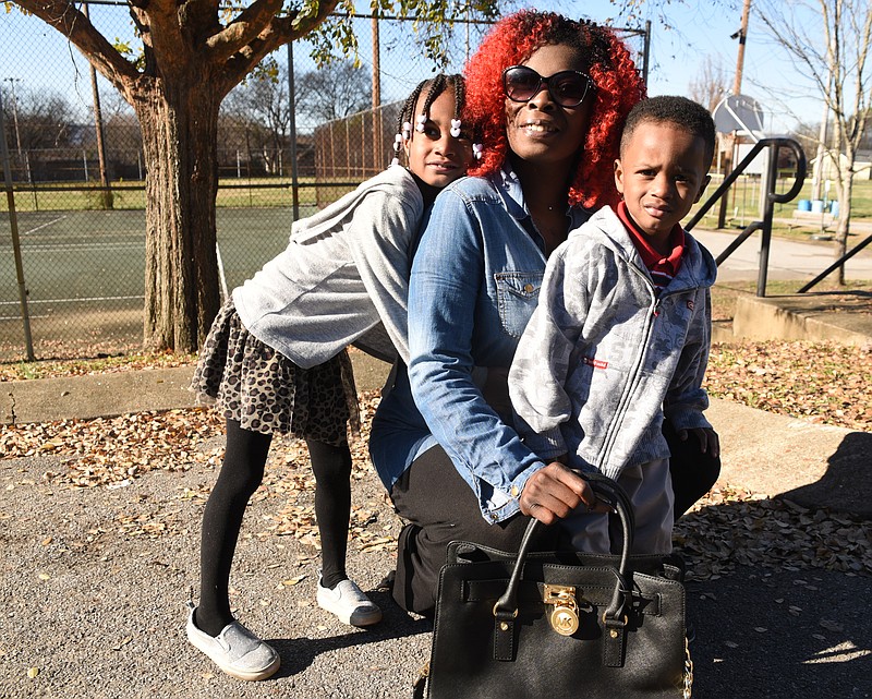 Heaven Satterfield, left, 4, and her brother, Taylor, 3, hug-up to their favorite glam-mother Amy Smartt Friday outside the Avondale Youth and Family Development Center on Dodson Ave.