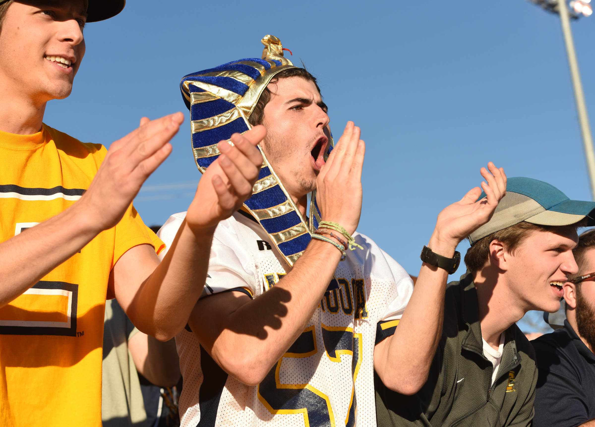UTC students Philip Calkins, left, Wil Pope and Jacob Scott cheer as the Mocs go ahead 35-28, late in the fourth quarter.