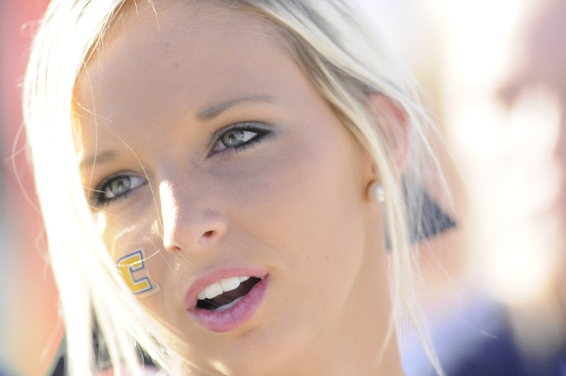 UTC cheerleader Cruze Smith wears her "C" on her cheek as the Mocs struggle in the first half of play.