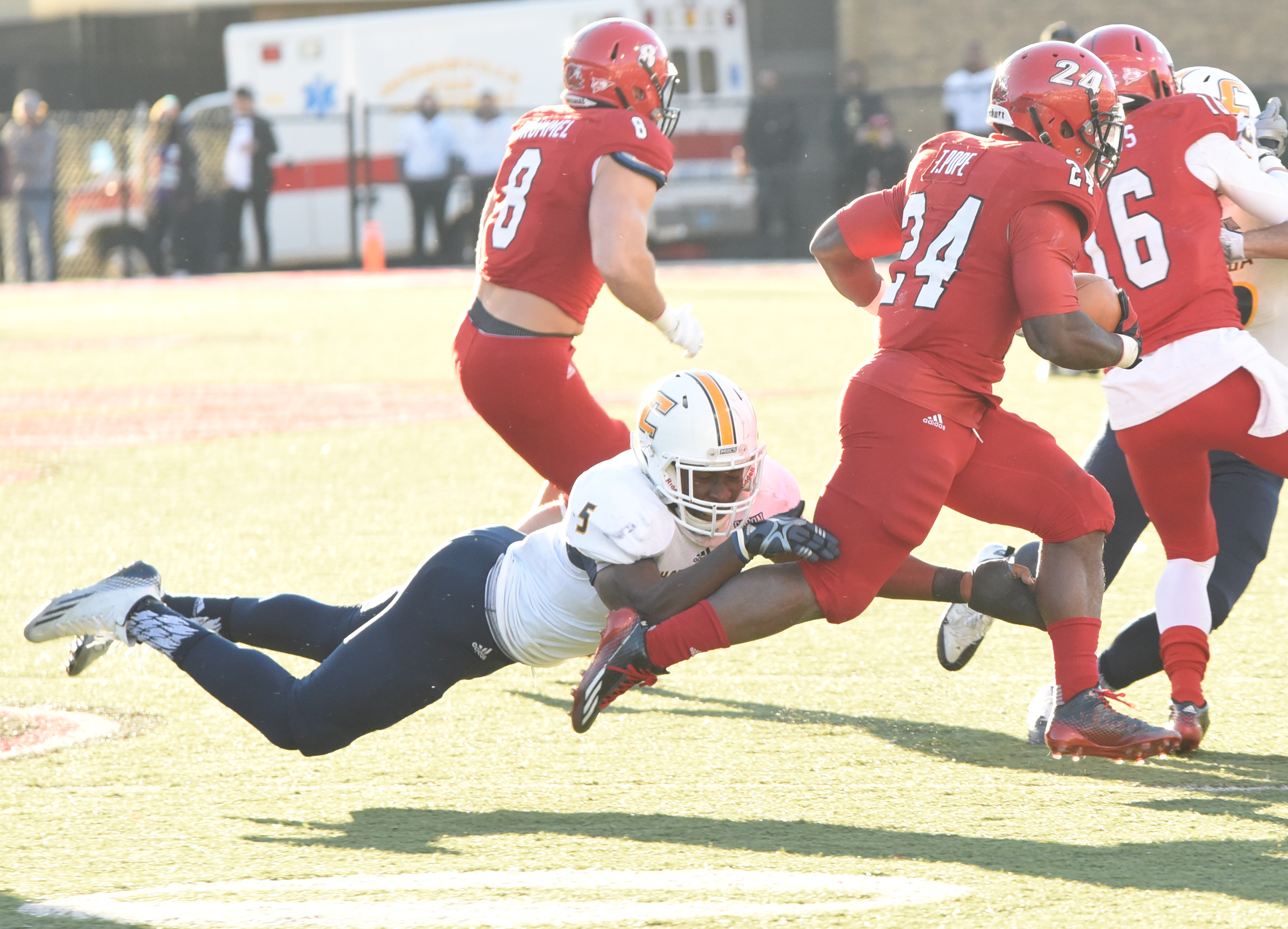 UTC's Nakevian Leslie (5) make a leg tackle on Jacksonville State running back Troymaine Pope (24) who later scored the tying touchdown to send it into overtime Saturday afternoon.