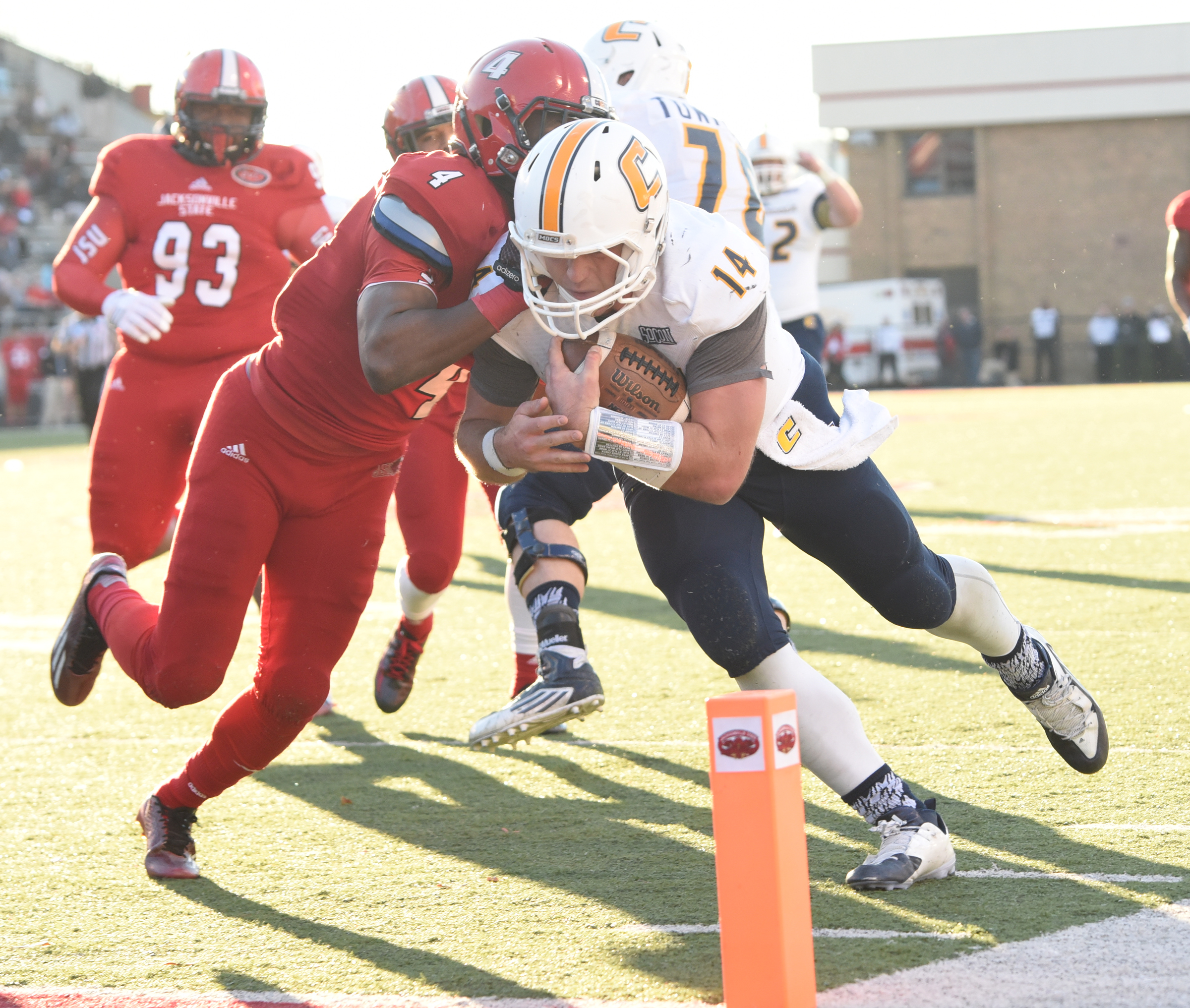 Jacob Huesman (14) dives for the fourth quarter go-ahead touchdown with Jacksonville State's Folo Johnson (4) defending. The pushed the score to 35-28.