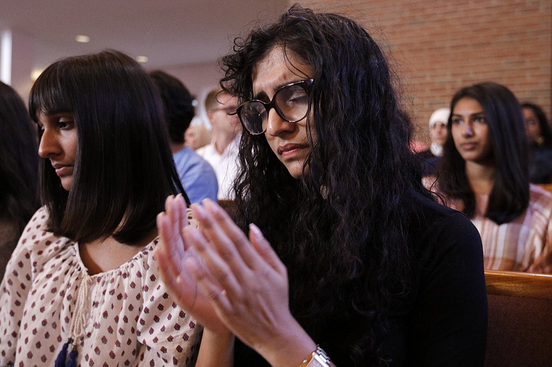 Yusra Siddiqui, right, and Zoha Ahmad, who came with others from the Islamic Society of Greater Chattanooga to offer their support, pray during an interfaith vigil at Olivet Baptist Church held in remembrance of victims of the July, 16 shootings on Friday, July 17, 2015, in Chattanooga, Tenn. The vigil was held one day after gunman Mohammad Youssef Abdulazeez shot and killed four U.S. Marines and wounded two others and a Chattanooga police officer at the Naval Operational Support Center on Amnicola Highway shortly after firing into the Armed Forces Career Center on Lee Highway.