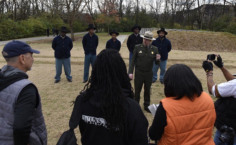 Park Ranger Chris Young of the National Park Service discusses the history of Camp Contraband after an event held on the Walnut Street Bridge on Sunday, Dec. 6, 2015, in Chattanooga, Tenn., to commemorate the 150th anniversary of the passage of the 13th Amendment to the Constitution. Standing behind him in Coolidge Park in front of a replica of a Union Army block house are students and faculty members from Brainerd High School, from left, Kim Prout, Isaiah Smith, Arlandis Barney, Keon Stevenson and Quincy Harris. 