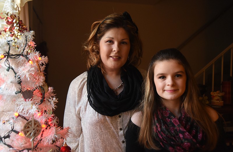 Sarah Hixson and her daughter, Alaina "Ally" Hixson, stand in their home Thursday, December 3, 2015.