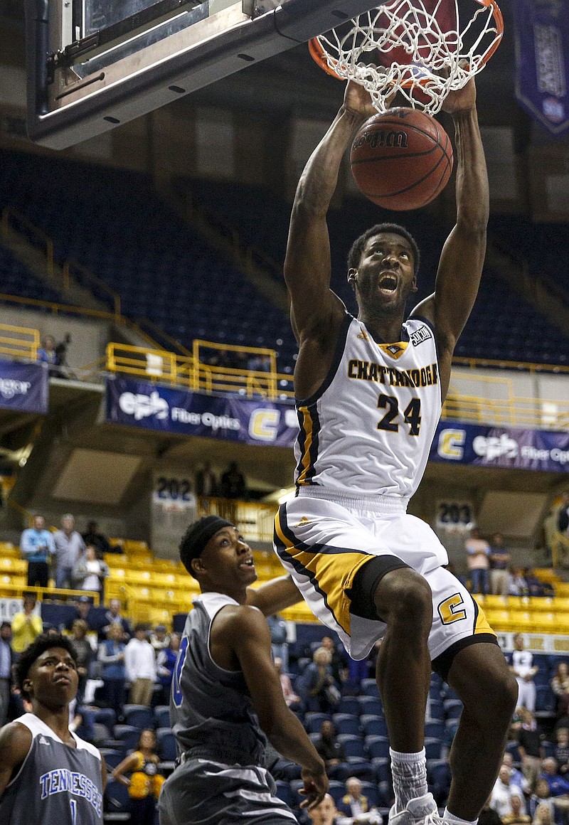 Chattanooga guard Casey Jones (24) dunks over Wesleyan guard Charles White during the Mocs' home basketball game against Tennessee Wesleyan at McKenzie Arena on Tuesday, Dec. 8, 2015, in Chattanooga, Tenn.