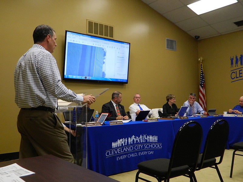 In a recent meeting with the Cleveland City Schools Board of Education, Cleveland Middle School principal Mike Collier, left, reviews costs and specs concerning the proposed purchase of portable bleachers for the middle school's ballfields.