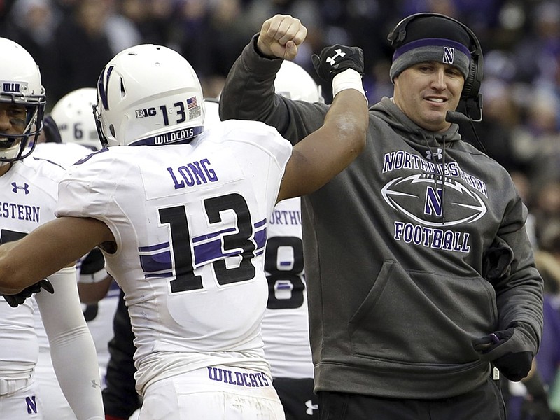 Northwestern football coach Pat Fitzgerald celebrates with running back Warren Long after a touchdown by Long during the Wildcats' win over Illinois last month. Like Tennessee, which will face Northwestern in the Outback Bowl on New Year's Day, the Wildcats have won five straight games.