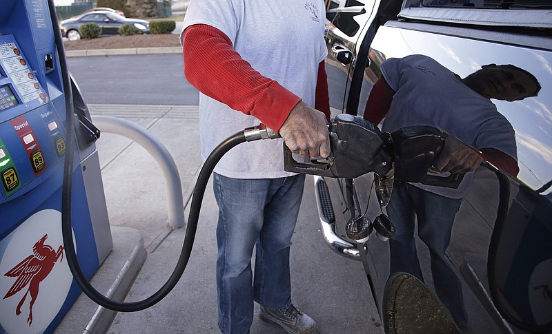 A customer prepares to pump gas at a gas station.