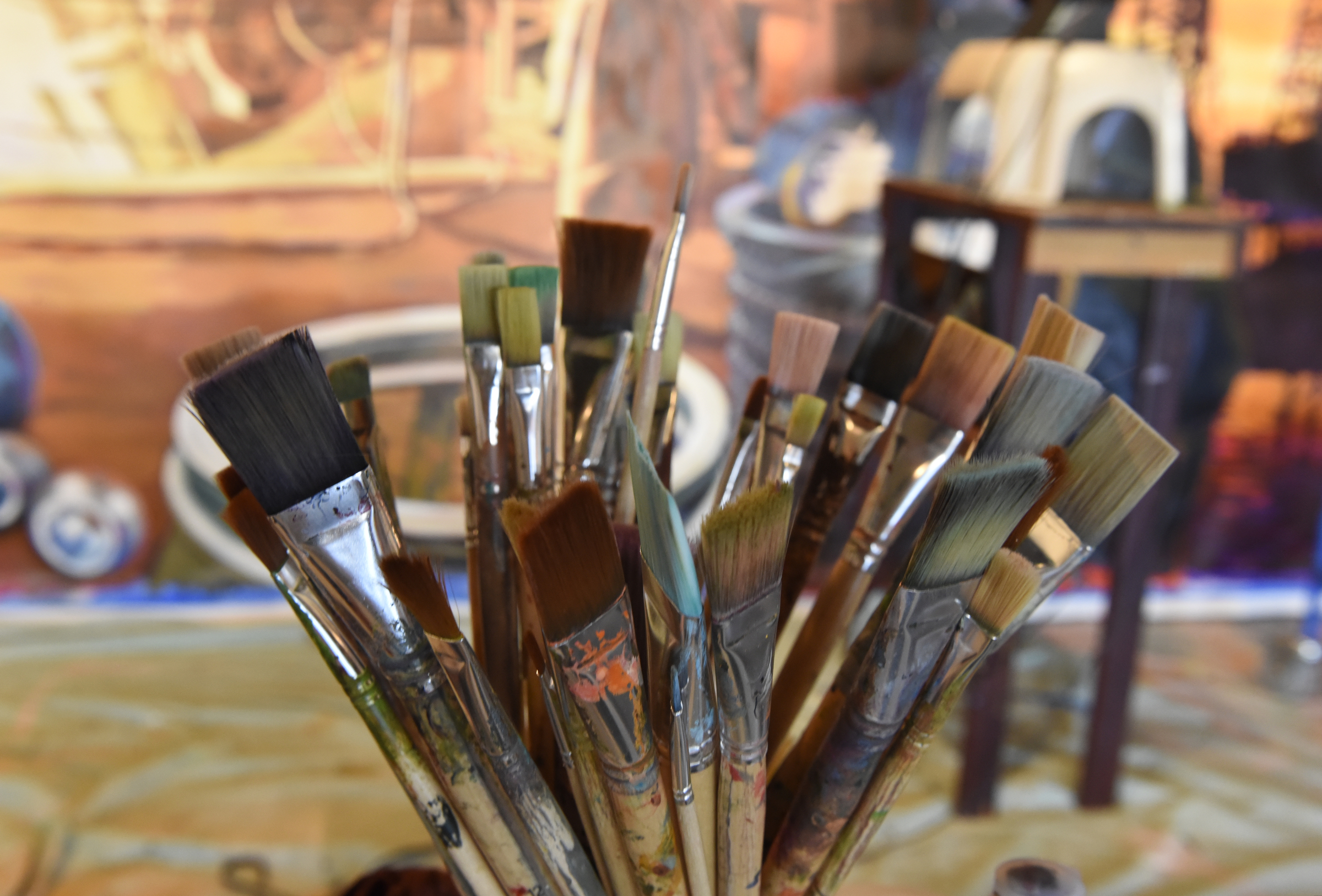 Ali Kay's brushes are seen as she works on a mural in the lobby of the Chattanooga WorkSpace building on Thursday, Nov. 19, 2015, in Chattanooga, Tenn. This mural, eight feet tall and 21 feet wide, is one of eight of her murals that will be displayed in offices of MetalTek around the country.