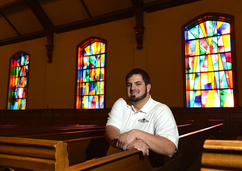 Steven Ryan sits inside of the Brainered Church of Christ, Thursday, December 10, 2015. Ryan will be setting up a new funeral home in the former church.