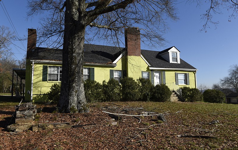 A house owned by Dr. James Newby is seen at the entrance to the Mahala Acres subdivision on Shallowford Road on Tuesday, Dec. 8, 2015, in Chattanooga, Tenn. Dr. Newby painted most of the brick walls of the house bright green due to a dispute with neighbors about changing the property's zoning to commercial. 