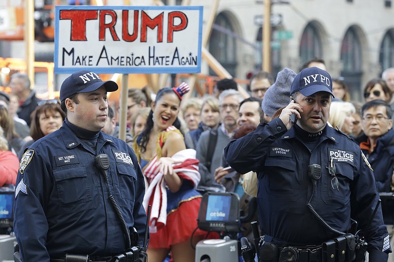 
              Police officers with the Counter Terrorism unit stand guard as activists protest against Republican presidential candidate Donald Trump outside The Plaza Hotel, where Trump is attending the Pennsylvania Republican party's annual Commonwealth Club luncheon, Friday, Dec. 11, 2015, in New York. (AP Photo/Mary Altaffer)
            