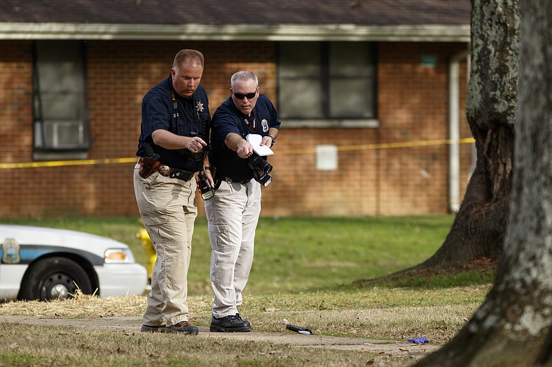 Hamilton County Sheriff's office investigators work the scene of a Chattanooga Police officer-involved shooting at Emma Wheeler Homes on Saturday, Dec. 12, 2015, in Chattanooga, Tenn. Chattanooga Police Chief Fred Fletcher said that multiple officers shot and killed Javario S. Eagle, 24, after he endangered the lives of a child and officers while armed with a handgun outside of an apartment at 5113 Woodland View Circle.