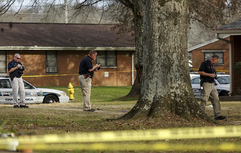 Hamilton County Sheriff's office investigators work the scene of a Chattanooga Police officer-involved shooting at Emma Wheeler Homes on Saturday, Dec. 12, 2015, in Chattanooga, Tenn. Chattanooga Police Chief Fred Fletcher said that multiple officers shot and killed Javario S. Eagle, 24, after he endangered the lives of a child and officers while armed with a handgun outside of an apartment at 5113 Woodland View Circle.