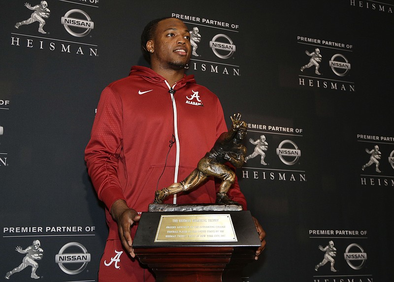 Alabama's Derrick Henry poses for photos with the Heisman Trophy, Friday, Dec. 11, 2015, in New York. Henry, along with Clemson's Deshaun Watson and Stanford's Christian McCaffrey, is a finalist for the trophy which recognizes college football's best player of the year. (AP Photo/Julie Jacobson) 