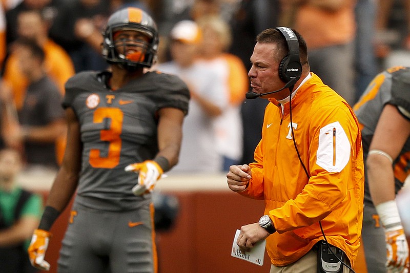 Tennessee head football coach Butch Jones, right, shouts to players as wide receiver Josh Malone looks on during their SEC football game against Georgia at Neyland Stadium on Saturday, Oct. 10, 2015, in Knoxville, Tenn. Tennessee won 38-31.