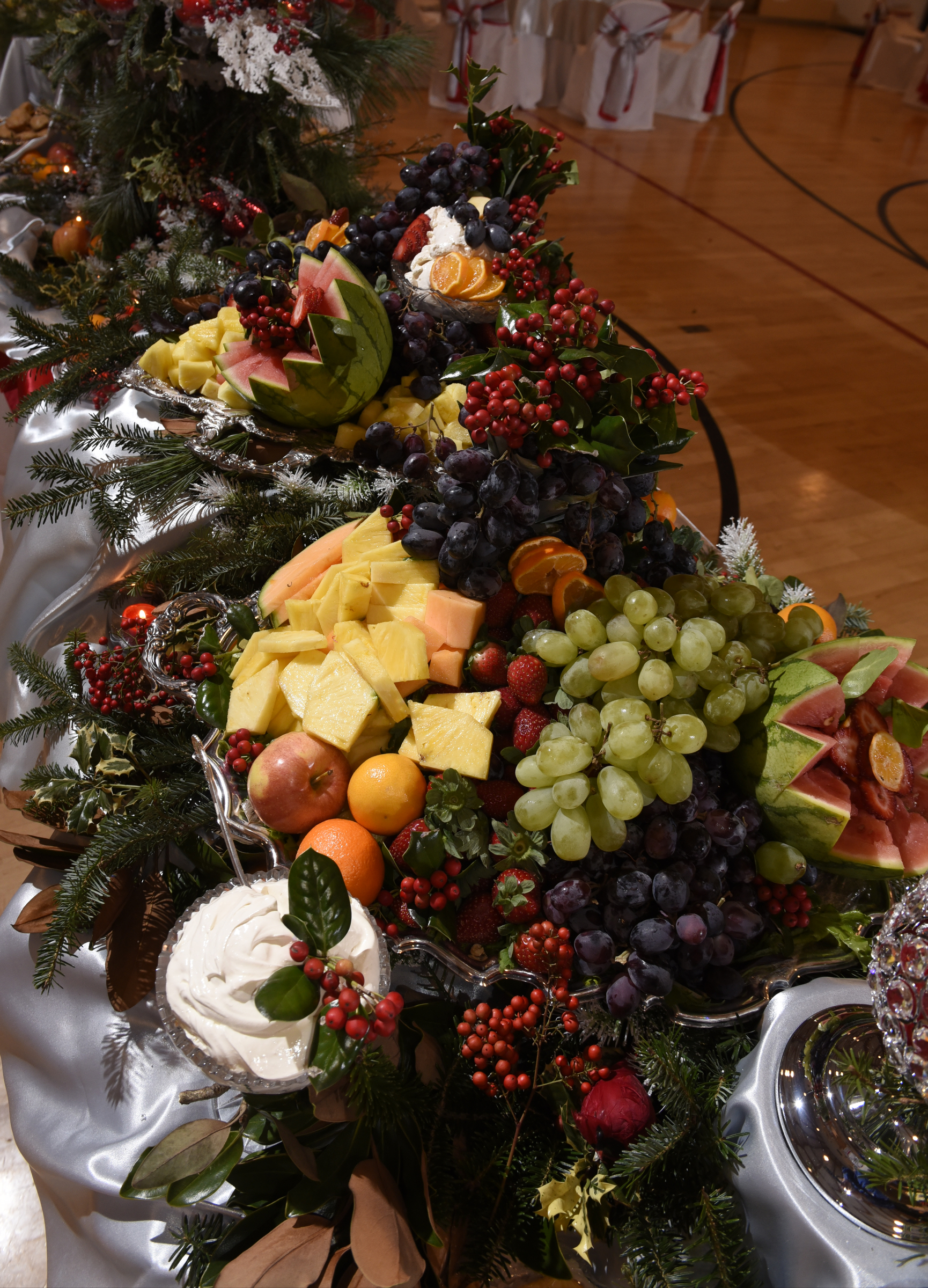 Arrangements of fruit prepared by Darvin Roberts, entwined with live greenery and berries, appeared to flow down platters set on multiple height levels.