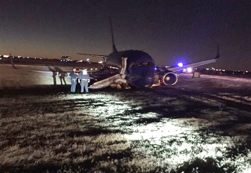 
              Emergency personnel standby a Southwest Airlines plane that rest on the ground after skidding off the runway at Nashville International Airport, Tuesday, Dec. 15, 2015, in Nashville, Tenn. Officials say three people were injured. (Carson O'Shoney via AP)
            