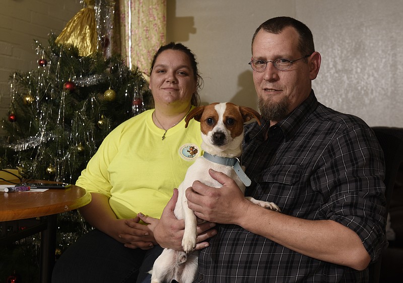 Photographed on Sunday, Dec. 13, 2015, in Chattanooga, Tenn., Ashley Harmon, left, and Joshua Adamson, holding their new dog Shorty, were homeless until the Neediest Cases fund provided them with $393.96 so that they could have a place to live. 