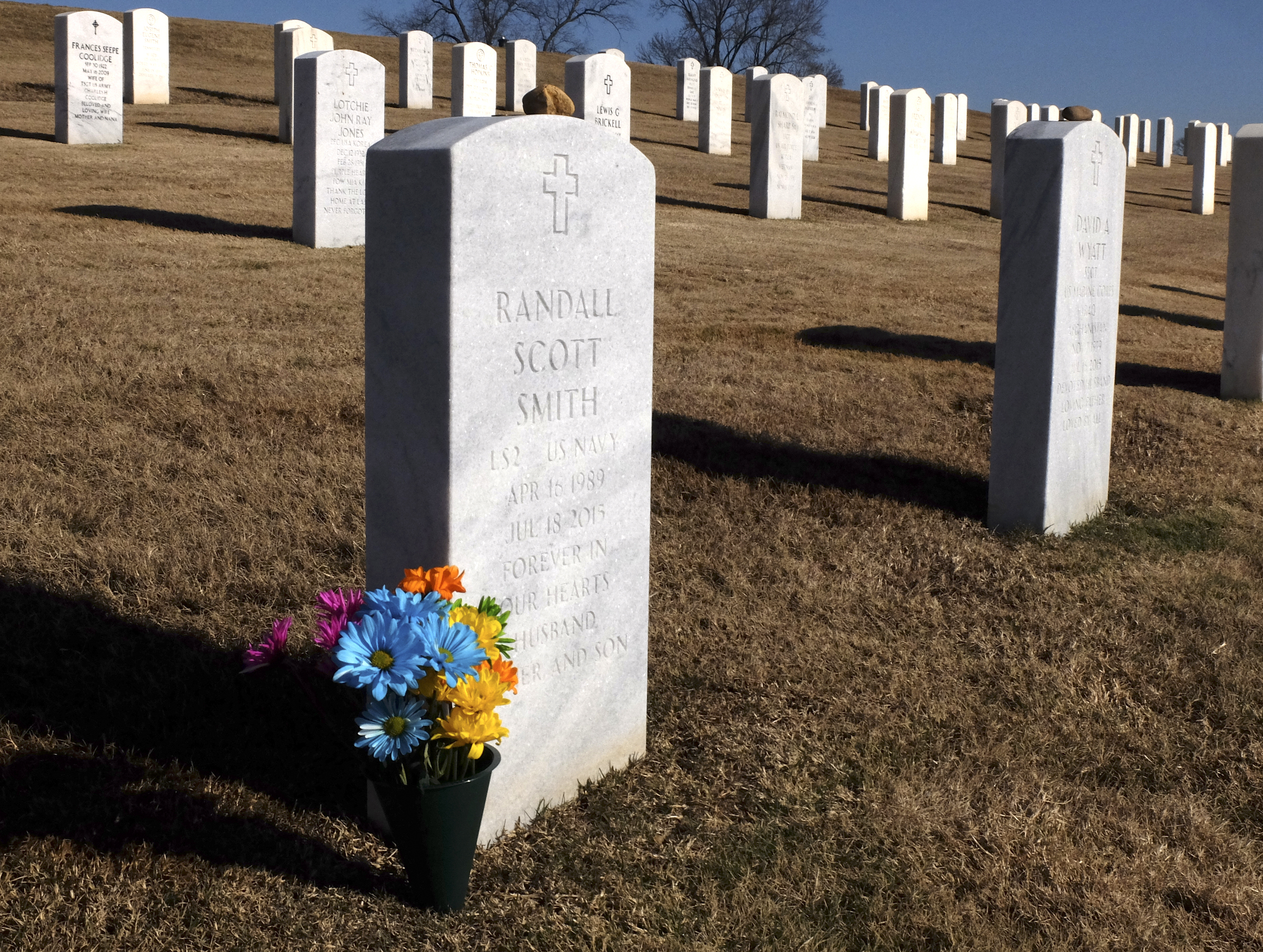 The head stone of U.S. Navy LS2 Randall Scott Smith is situated beside Marine SSgt David A. Wyatt, right, at the Chattanooga National Cemetery.