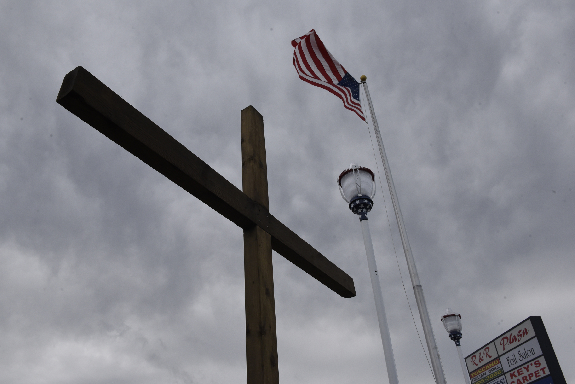 A wooden cross has been erected at the memorial to the five service members killed in a terror incident on July 16, 2015, seen Monday, Dec. 14, 2015, in Chattanooga, Tenn. The memorial is located in front of the Armed Forces Career Center on Lee Highway next to Highway 153, the scene of the first shots fired in the July attack.