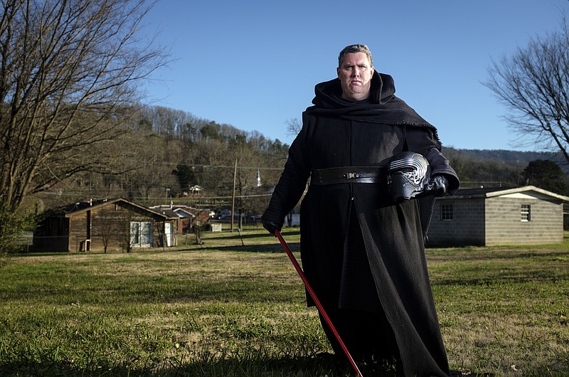 Alex McKeel poses in his Kylo Ren costume, a villain from the newly released Star Wars: Episode VII - The Force Awakens film, at his home Tuesday, Dec. 15, 2015, in Chattanooga, Tenn.