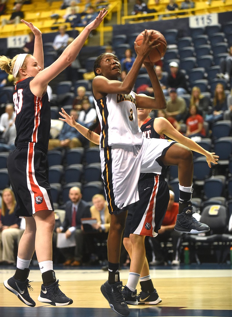 UTC's Jasmine Joyner takes a shot as Belmont's Ellie Harmeyer guards Wednesday, December 16, 2015 at McKenzie Arena.