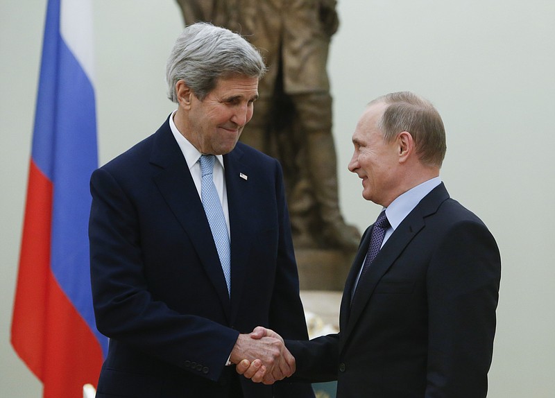 Russian President Vladimir Putin, right, shakes hands with U.S. Secretary of State John Kerry during their meeting in the Kremlin in Moscow, Russia, Tuesday, Dec. 15, 2015.