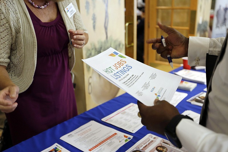 
              In this Tuesday, Oct. 6, 2015, photo, military veteran Mark Cannon, of Miami, right, talks with Cynthia Carcillo, left, a veterans outreach representative for Career Source Broward, about employment opportunities at a job fair for veterans, in Pembroke Pines, Fla.  Fewer Americans applied for unemployment claims last week, another sign of strength in the job market.  Weekly applications for unemployment benefits fell 11,000 last week to a seasonally adjusted 271,000, the Labor Department said Thursday, Dec. 17, 2015(AP Photo/Lynne Sladky)
            