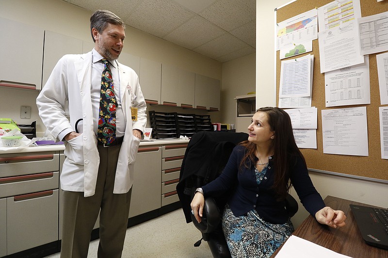 Staff Photo by Dan Henry / The Chattanooga Times Free Press- 12/14/15. Dr Mark Anderson, an infectious disease specialist, and medical case manager Tania Mull work in their office in the Memorial Medical Building on Monday, December 14, 2015. 