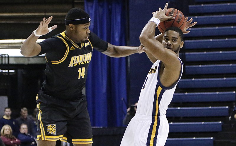 Staff Photo by Dan Henry / The Chattanooga Times Free Press- 12/18/15. Chattanooga's Greg Pryor (1) looks for an open teammate as Kennesaw's Aubrey Williams (14) defends during their matchup at McKenzie Area. 