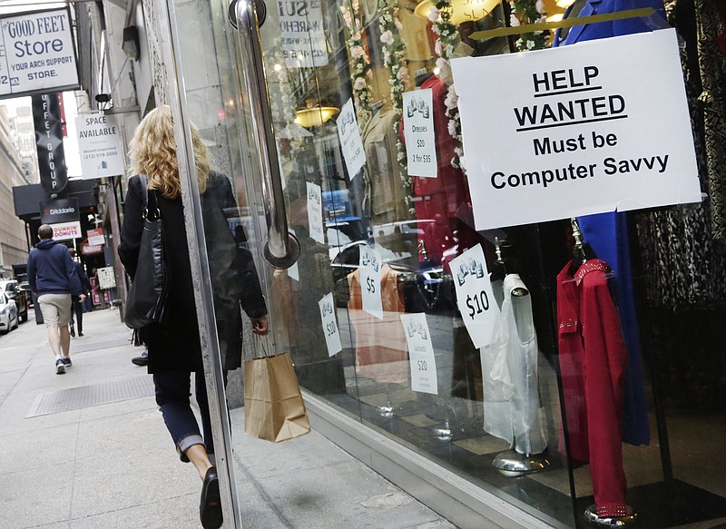 
              In this Oct. 1, 2015 photo, a shopper walks past a store with a "Help Wanted" sign in the window, in New York.  The Labor Department said Friday, Dec. 18, 2015 that jobless rates fell in 27 states, rose in 11, and were unchanged in 12 states. Employers added jobs in 35 states, while employment fell in 14. Montana’s job total was flat last month. (AP Photo/Mark Lennihan)
            