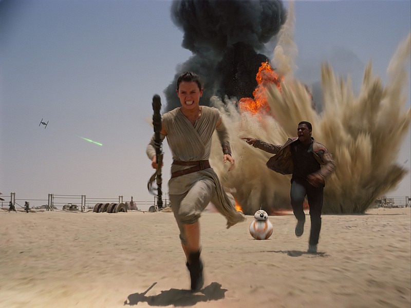 This photo provided by Disney shows Daisey Ridley as Rey, left, and John Boyega as Finn, in a scene from the new film, "Star Wars: Episode VII - The Force Awakens," directed by J.J. Abrams. The movie releases in the U.S. on Dec. 18, 2015. (Film Frame/Disney/Copyright Lucasfilm 2015 via AP)