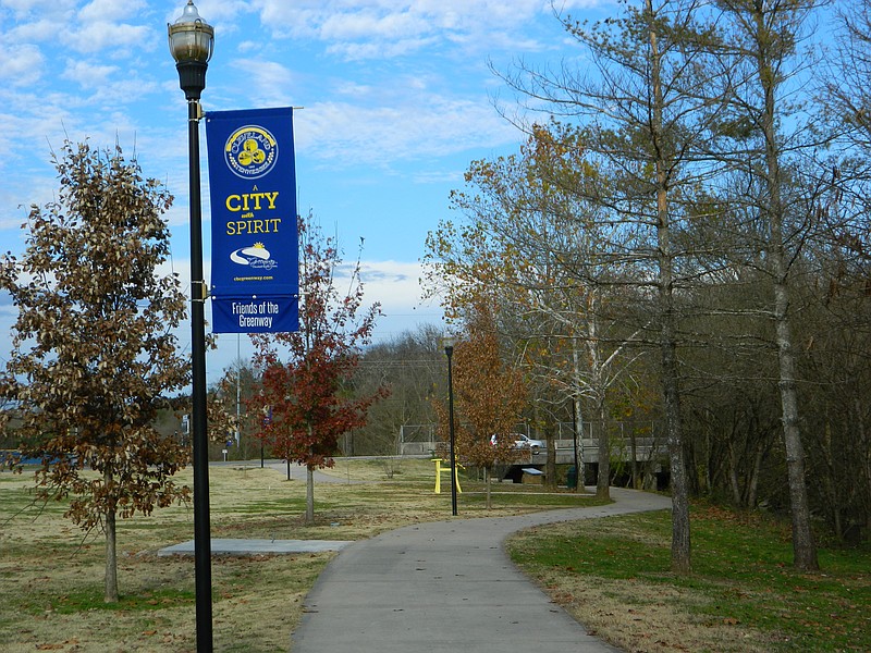 A banner bearing the Cleveland motto "A City With Spirit" decorates the Cleveland/Bradley County Greenway near Raider Drive.
