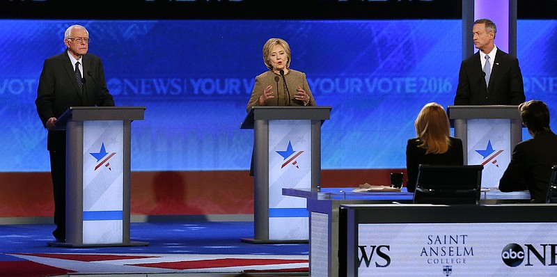 
              Hillary Clinton, center, speaks between Bernie Sanders, left, and Martin O’Malley during a Democratic presidential primary debate Saturday, Dec. 19, 2015, at Saint Anselm College in Manchester, N.H. (AP Photo/Jim Cole)
            