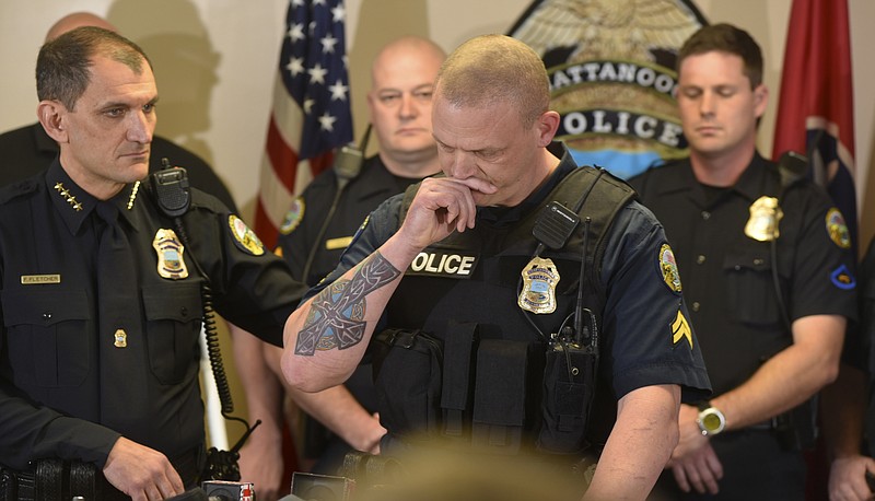 Chattanooga Police Department Chief Fred Fletcher, left, puts his hand on the back of Master Patrol Officer Sean O'Brien as he pauses to compose himself in a news conference on Monday, Dec. 21, 2015, in Chattanooga, Tenn., as he talks about the five service members killed in Chattanooga in July.  Among those standing with him are Jeff Lancaster, left, and Kevin Flanagan. O'Brien, Lancaster and Flanagan, along with officers Grover Wilson and Lucas Timmons, returned fire on Muhammad Youssef Abdulazeez on July 16, killing the attacker. 