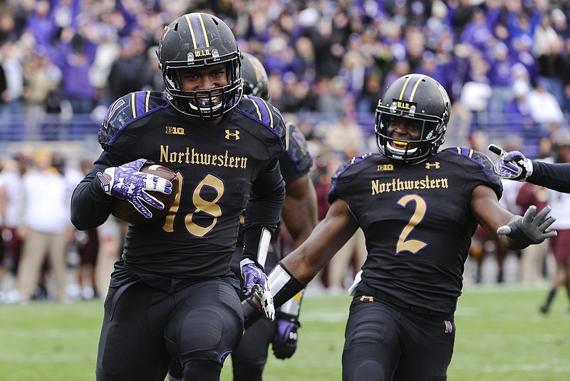 Northwestern linebacker Anthony Walker (18) runs for a touchdown against Minnesota after picking up a fumble, as safety Traveon Henry (2) looks on. Northwestern won that game 27-0 and faces Tennessee in the Outback Bowl on New Year's Day.