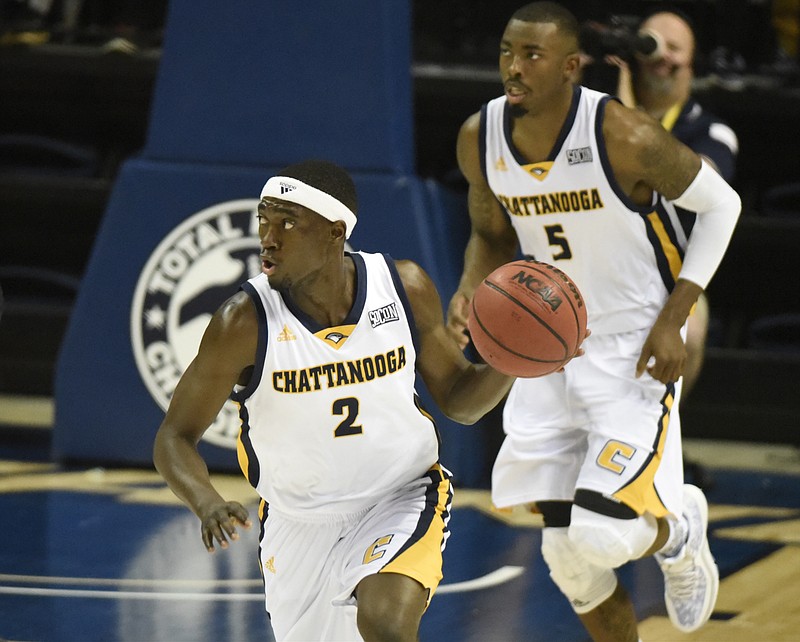 Followed by Justin Tuoyo, UTC's Dee Oldham brings the ball up the court as the University of Tennessee at Chattanooga hosts Hiwassee College in a men's basketball game Monday, Nov. 16, 2015, in Chattanooga, Tenn. UTC won their home opener by a score of 94-55.