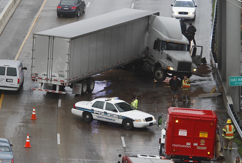 A jackknifed tractor trailer blocks two lanes of I-24 traffic during a 2012 morning commute.