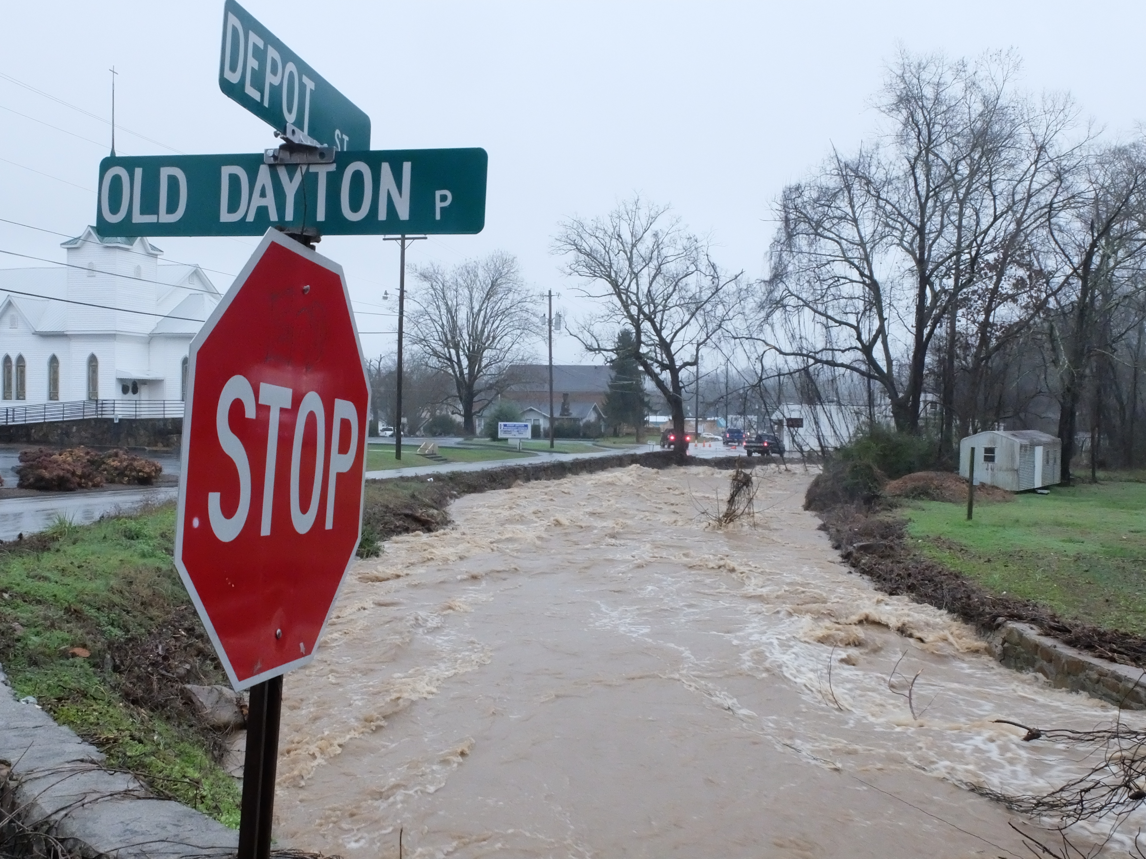 Little Soddy creek flows and gets out of its banks Friday morning on Durham Avenue, just south of Old Dayton Pike in Soddy.