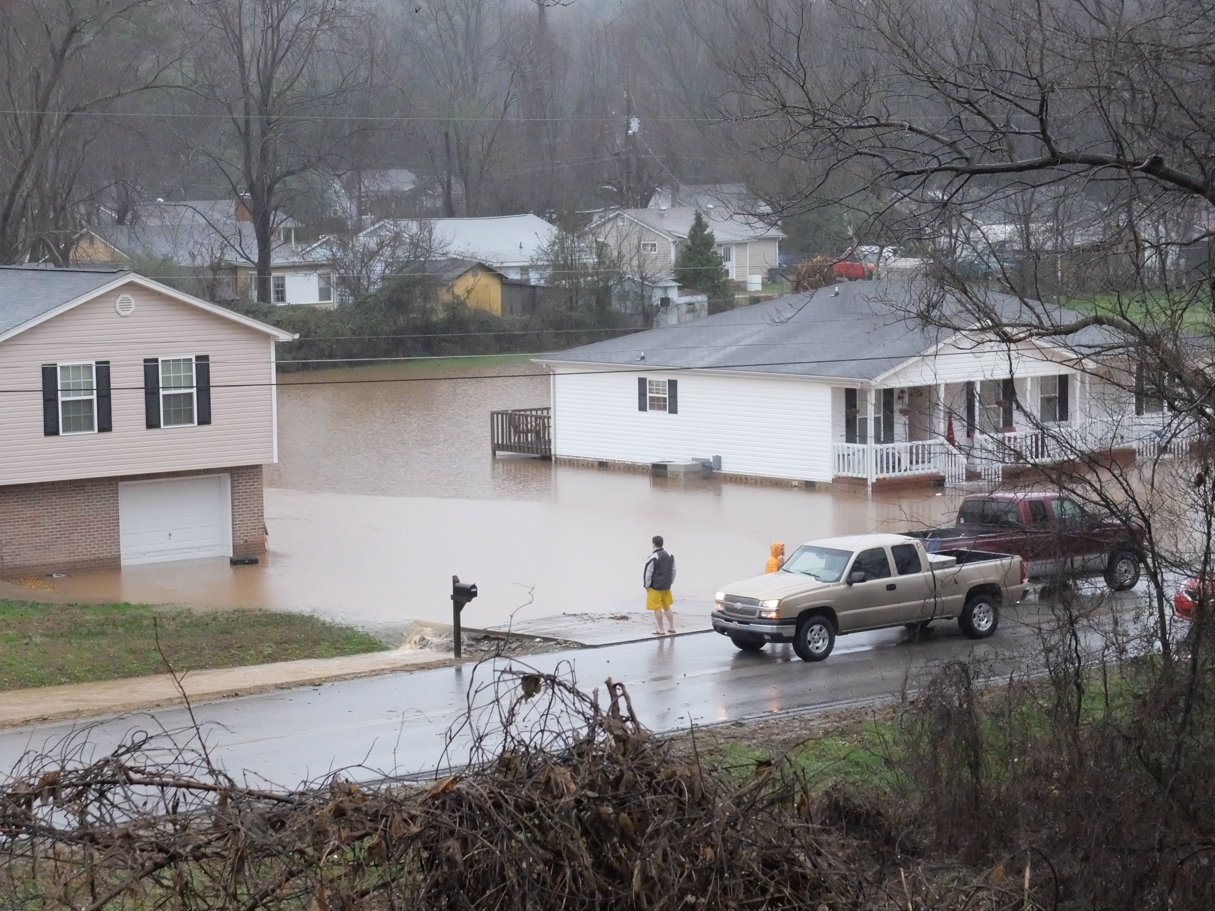 Soddy-Daisy residents look at their home as water rises on Vine Street, just south Sequoyah Access Road Friday morning.